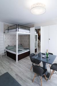 a living room with a dining table and a bunk bed at CozyNite Premium Apartment Favoriten 1 in Vienna