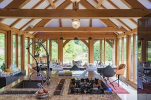 an open kitchen and living room with wooden ceilings at Bacchus by Bloom Stays in Canterbury