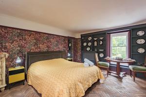 a bedroom with a bed and a table and chairs at Bacchus by Bloom Stays in Canterbury