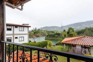 a view of a river from the balcony of a house at Soy Local Guatape in Guatapé +82 photos