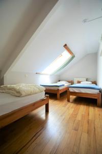 a room with two beds and a skylight at Achouffe - MASSON in Houffalize