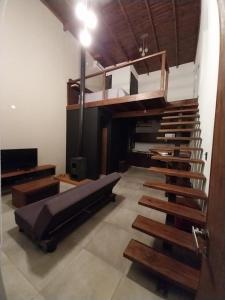 a room with a loft bed and a staircase at Loft de Montaña in Río Ceballos