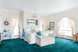 a bedroom with a large bed and a chair at Greystone on Golden Lake in Deacon