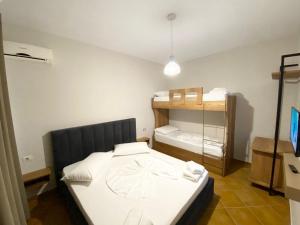 Cette petite chambre comprend un lit et des lits superposés avec une étagère. dans l'établissement Hotel Amantia, à Orikum