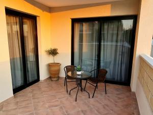 a patio with a table and chairs on a balcony at PylaApts - Apartments near the beach in Pyla