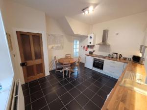 a kitchen with a table and a dining room at Character cottage in centre of Moffat in Moffat