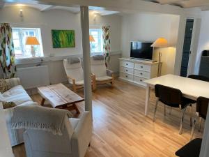 a living room with a couch and a table at Strandsegård Ferielejlighed in Ølsted