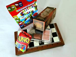 a wooden chess board with three boxes of candy at PylaApts - Apartments near the beach in Pyla