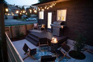 a patio with chairs and a grill on a house at The Blue Door Bungalow - Oldtown, Well-Equipped Kitchen in Loveland