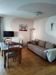 a living room with a couch and a table at Apartments Angela in Wiesau