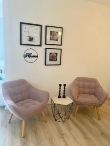Duas cadeiras e uma mesa numa sala de estar em SMILJANA em Banja Koviljača
