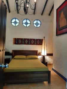 a bedroom with a bed and three windows at Casa Constantino in Rivera