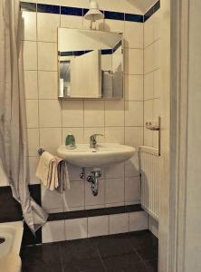 a bathroom with a sink and a mirror at Ferien-Messe-Handwerker- Apartment Bensberg in Bergisch Gladbach
