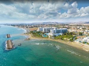 an aerial view of a beach with buildings and the ocean at PylaApts - Apartments near the beach in Pyla