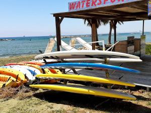 a bunch of surfboards are lined up on the beach at PylaApts - Apartments near the beach in Pyla