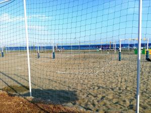 a volley ball net on a sandy beach at PylaApts - Apartments near the beach in Pyla