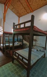 a room with two bunk beds in it at El Gordo's Seaside Adventure Lodge in El Nido