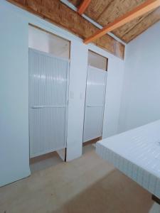 two closets in a room with white walls at El Gordo's Seaside Adventure Lodge in El Nido