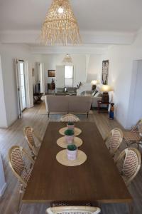 uma sala de estar com uma mesa de madeira e cadeiras em Moradia de férias Casa do Chorão - Montargil em Montargil