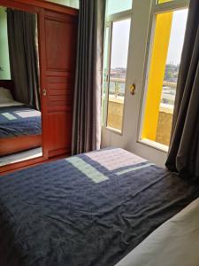 a bedroom with a bed next to a window at Penthouse au coeur de Yaoundé Quartier Bastos in Yaoundé