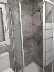 a shower with a glass door in a bathroom at Villa Romadian in Chiclana de la Frontera