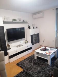 a living room with a large flat screen tv at APARTMAN D&D*** in Varaždin