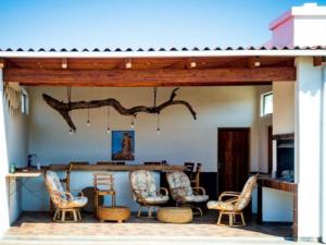 a patio with chairs and a table and a bar at Beach Garden Guesthouse with Self Catering in Swakopmund