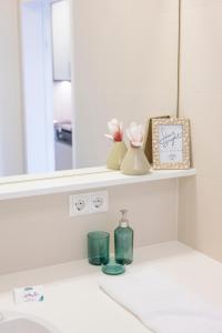 a bathroom counter with a shelf with a mirror at Modern City Hideaway Graz in Graz