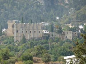 a castle on top of a hill with houses at Farm House in Kyrenia