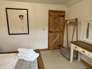 a bedroom with a bed and a wooden closet at North Gower Cottage in Llanmorlais