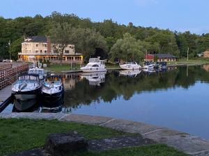 a group of boats are docked in a harbor at Hotel Kenney Rideau in Crosby