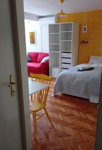 a bedroom with a bed and a table and a couch at Colors of Cvjetno Apartment in Zagreb