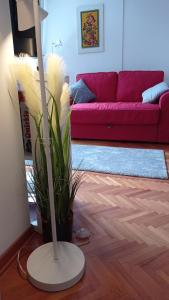 a living room with a red couch and a lamp at Colors of Cvjetno Apartment in Zagreb