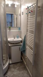 a bathroom with a sink and a shower at Colors of Cvjetno Apartment in Zagreb