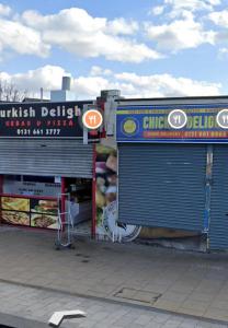 two store fronts with their doors open on a street at FABULOUS 2BED 2BATH Ground Floor SERVICED ACCOMMODATION Near CITY in Edinburgh