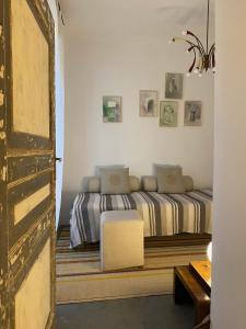 a bedroom with a bed and a chair in it at Casa Antonio Noto in Noto