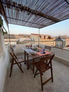 a table and chairs on a balcony with a view at Casa Antonio Noto in Noto +35 photos
