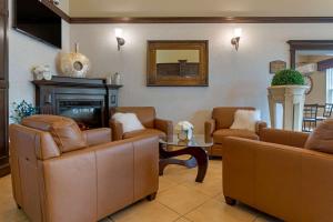 a living room filled with furniture and a coffee table at Best Western Plus Fredericton Hotel & Suites in Fredericton