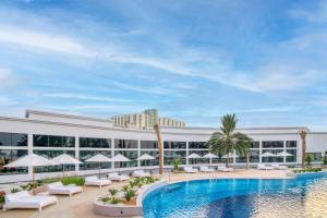 a large swimming pool in a large city at Radisson Blu Hotel & Resort, Abu Dhabi Corniche in Abu Dhabi