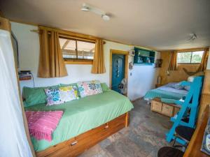 a bedroom with two beds and a ladder in it at Uka O Te Ra´a Cabaña full equipada. in Hanga Roa