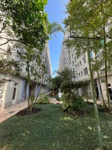 een park met bomen en een hoog gebouw bij Lindo Apartamento em Frente a Praia - Santos in Santos