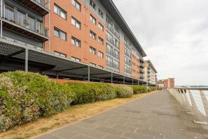 an empty sidewalk in front of a building at Lux Waterfront 2 bed Apt, V&A 10min walk, St Andrew's Golf 25min drive in Dundee