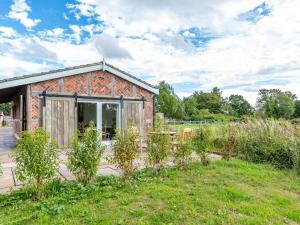 a barn conversion with a garden in the foreground at The Lodge in Chester