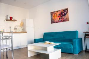 a living room with a blue couch and a table at Apartamentos Atenea Jerte in Jerte