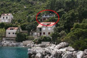 a house on a hill next to a river at Apartments by the sea Sobra, Mljet - 4898 in Babino Polje