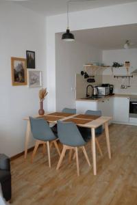 a kitchen with a table and chairs in a room at Bon Repos Apartmán in Donovaly