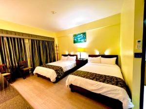 Postel nebo postele na pokoji v ubytování Serenti Hotel Saipan