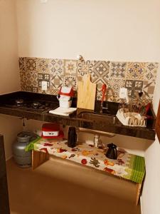 a kitchen with a sink and a counter top at Chalés por do sol in Pirenópolis