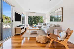 a living room with a couch and a table at Holiday Haven with Pool in Sorrento