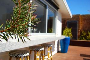 a row of stools on a porch with a window at Holiday Haven with Pool in Sorrento